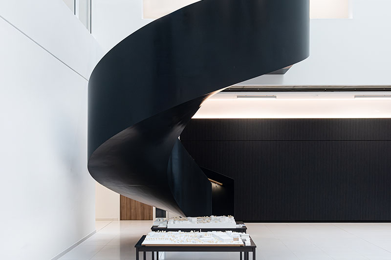 Modern black spiral staircase in contemporary interior.