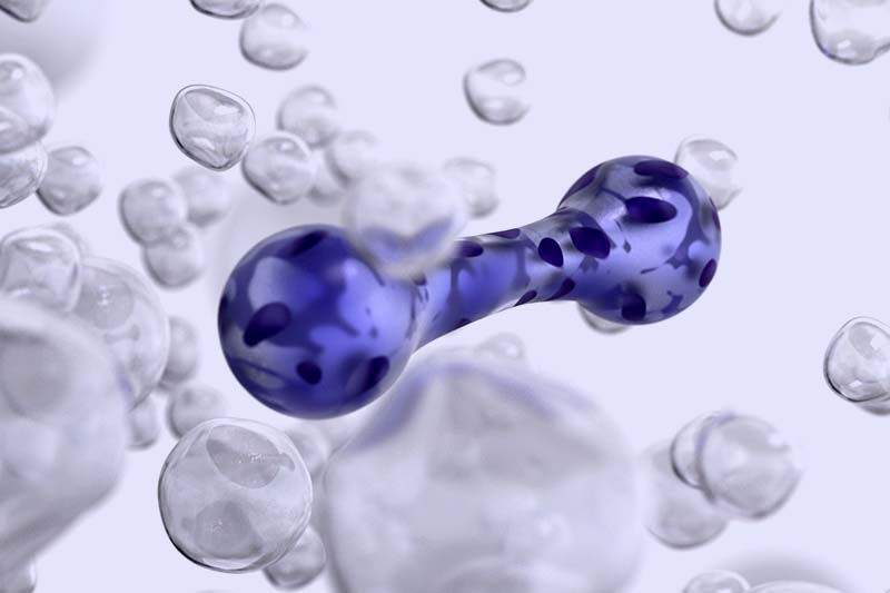 Transparent spheres with a blue spotted molecule model.